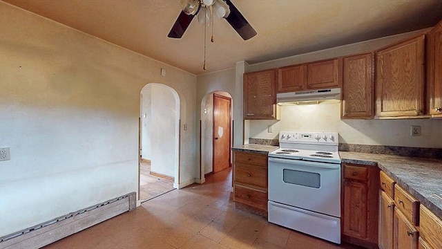 kitchen with under cabinet range hood, a baseboard heating unit, ceiling fan, electric stove, and arched walkways