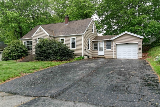 cape cod home with a chimney, aphalt driveway, a garage, a front yard, and roof with shingles