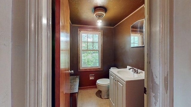 half bathroom featuring vanity, toilet, a wealth of natural light, and ornamental molding