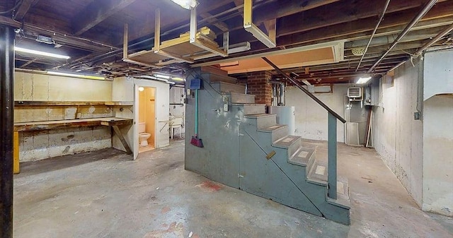 unfinished below grade area with gas water heater and stairs