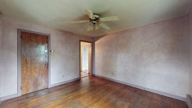 unfurnished room with baseboards, a baseboard radiator, ceiling fan, and wood finished floors