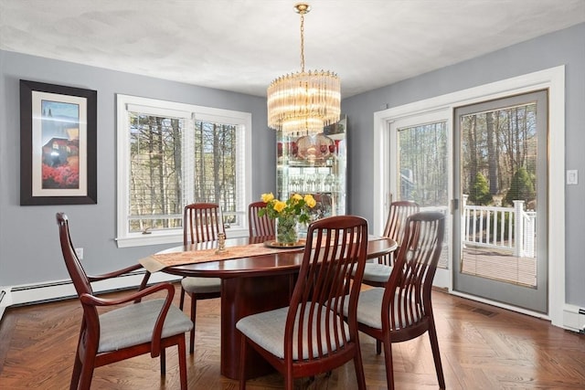 dining space with an inviting chandelier, baseboards, and a wealth of natural light