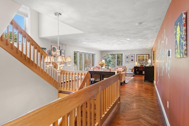 hallway featuring recessed lighting, stairway, a baseboard radiator, a notable chandelier, and baseboards