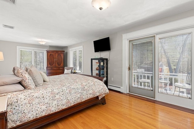 bedroom with a baseboard radiator, visible vents, access to exterior, and light wood-style flooring