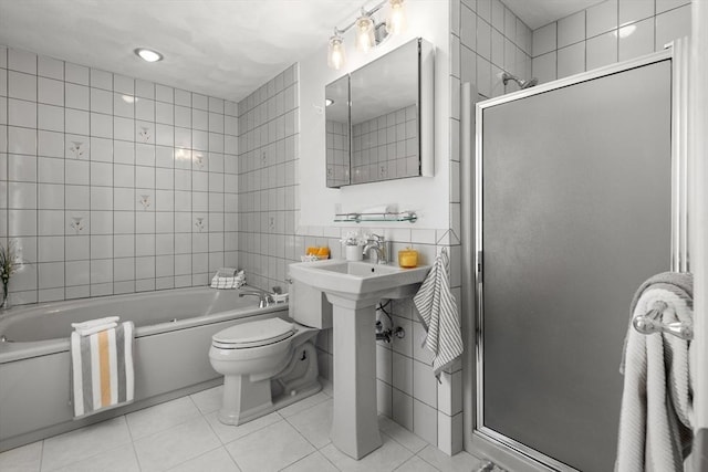 full bath featuring tile patterned floors, tile walls, a shower stall, and a garden tub