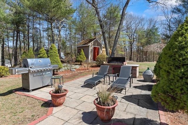 view of patio / terrace featuring a grill, an outdoor structure, and a storage unit
