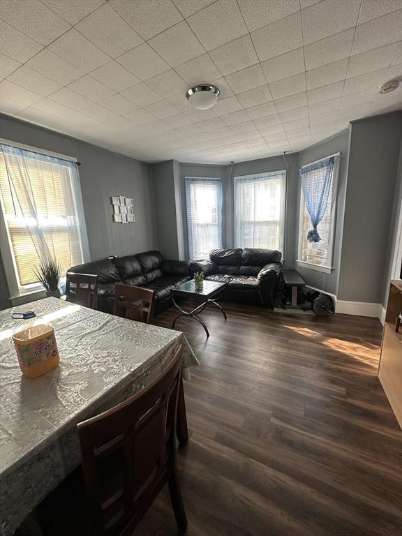 26 Woodman St, Lynn, MA 01905 - dining area with dark wood-style flooring and baseboards