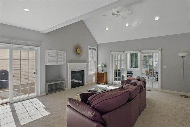 carpeted living room featuring high vaulted ceiling, recessed lighting, a fireplace, ceiling fan, and baseboards