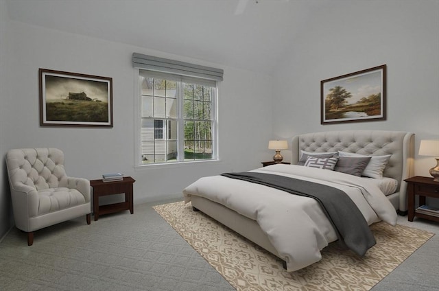 carpeted bedroom with baseboards and lofted ceiling