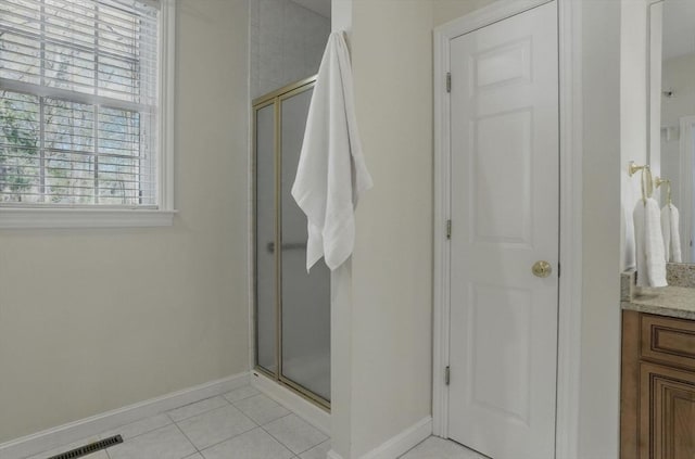 bathroom featuring baseboards, vanity, and a stall shower