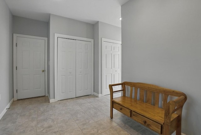 living area with light tile patterned floors and baseboards