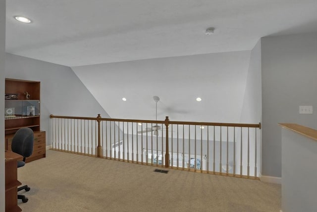unfurnished office featuring carpet flooring, visible vents, lofted ceiling, and recessed lighting