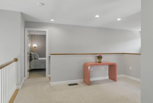 hallway featuring baseboards, recessed lighting, carpet flooring, and visible vents