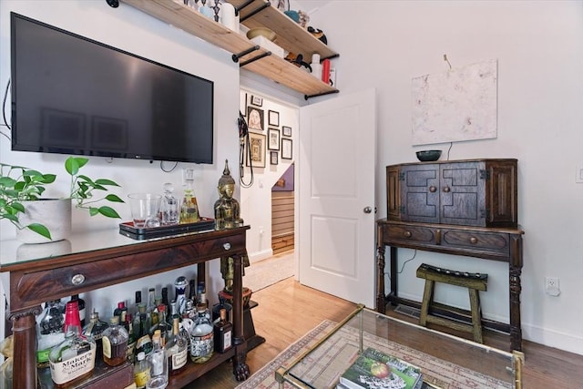 living room featuring wood finished floors and baseboards