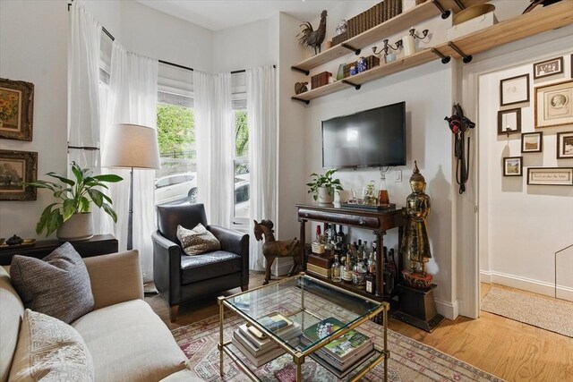 living room with wood finished floors and baseboards