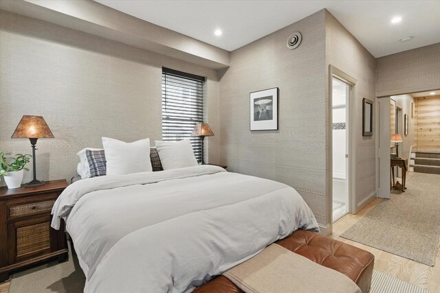 bedroom with light wood-style floors and recessed lighting