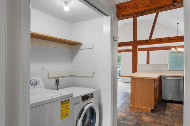 laundry area with washer and dryer, plenty of natural light, a chandelier, and stone finish floors