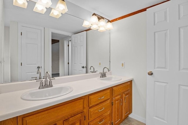 bathroom with double vanity, baseboards, and a chandelier