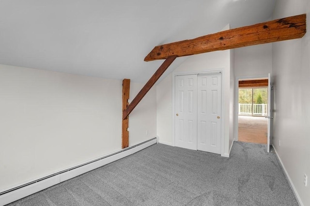 additional living space with a baseboard heating unit, vaulted ceiling, carpet flooring, and baseboards