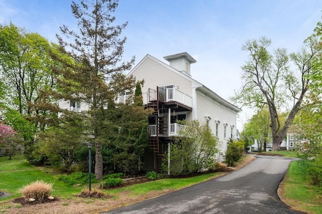 view of side of home featuring stairs
