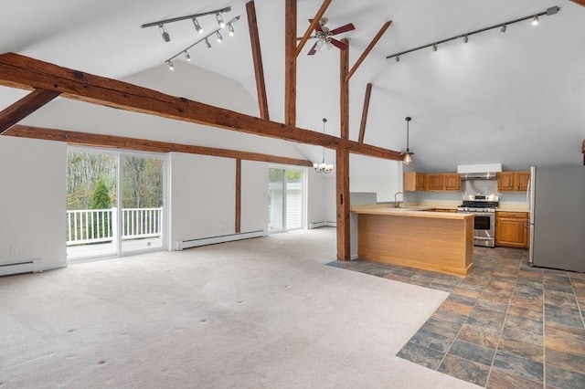 kitchen featuring appliances with stainless steel finishes, open floor plan, baseboard heating, rail lighting, and plenty of natural light