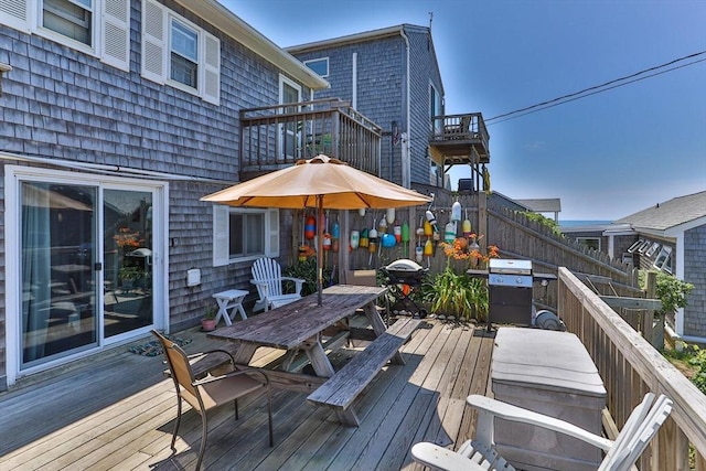 deck featuring outdoor dining space and area for grilling