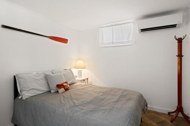 bedroom with an AC wall unit