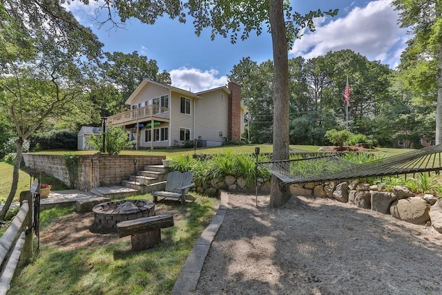 49 Edgewater Way, Wareham, MA 02571 - view of yard featuring a wooden deck, stairway, fence, and an outdoor fire pit