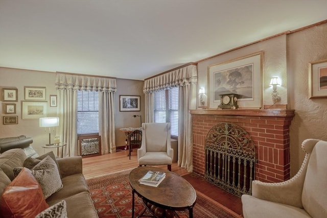 1142 Longmeadow St, Longmeadow, MA 01106 - living area with wood finished floors, healthy amount of natural light, a fireplace, and a textured wall