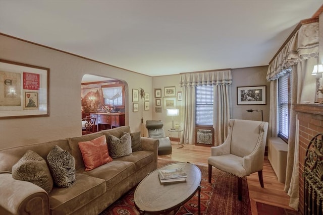 1142 Longmeadow St, Longmeadow, MA 01106 - living area with arched walkways and light wood-style floors