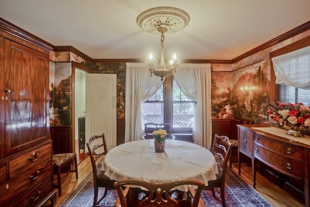 1142 Longmeadow St, Longmeadow, MA 01106 - dining space with a chandelier, wood finished floors, wainscoting, crown molding, and wallpapered walls