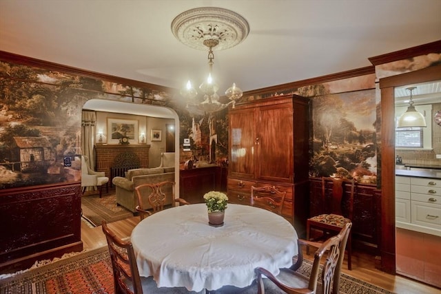 1142 Longmeadow St, Longmeadow, MA 01106 - dining room featuring wood finished floors, arched walkways, crown molding, and a chandelier