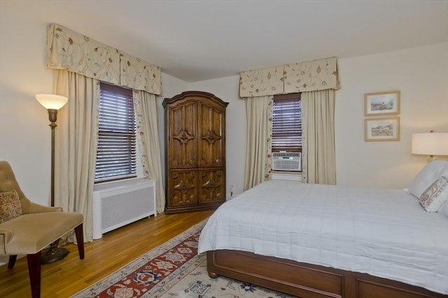 1142 Longmeadow St, Longmeadow, MA 01106 - bedroom with radiator heating unit, wood finished floors, and cooling unit