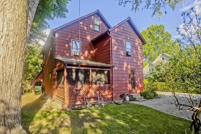 1142 Longmeadow St, Longmeadow, MA 01106 - rear view of property featuring a sunroom and a lawn