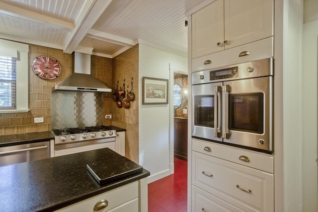 1142 Longmeadow St, Longmeadow, MA 01106 - kitchen with wall chimney range hood, appliances with stainless steel finishes, backsplash, white cabinetry, and crown molding