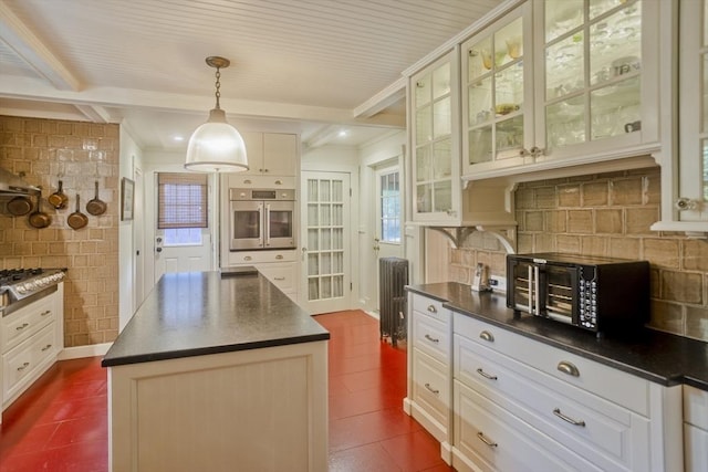 1142 Longmeadow St, Longmeadow, MA 01106 - kitchen with oven, dark countertops, glass insert cabinets, ornamental molding, and a center island