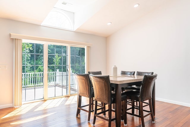 dining room with lofted ceiling and hardwood / wood-style floors