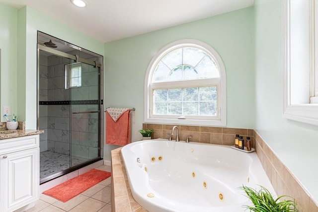 bathroom featuring tile patterned floors, plus walk in shower, and vanity