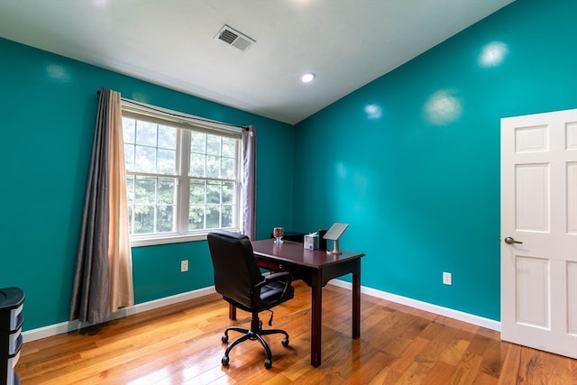 home office with hardwood / wood-style flooring and lofted ceiling