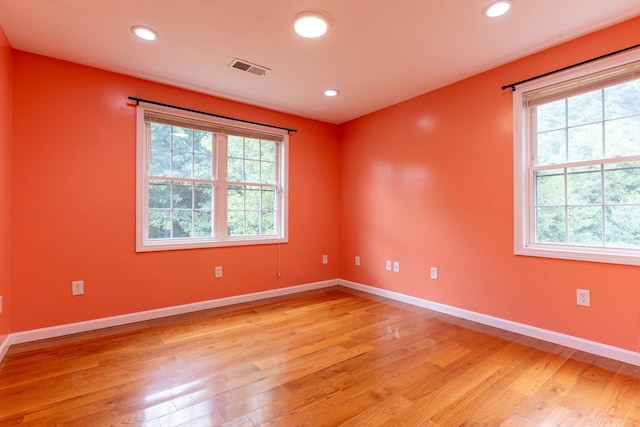 unfurnished room with light wood-type flooring