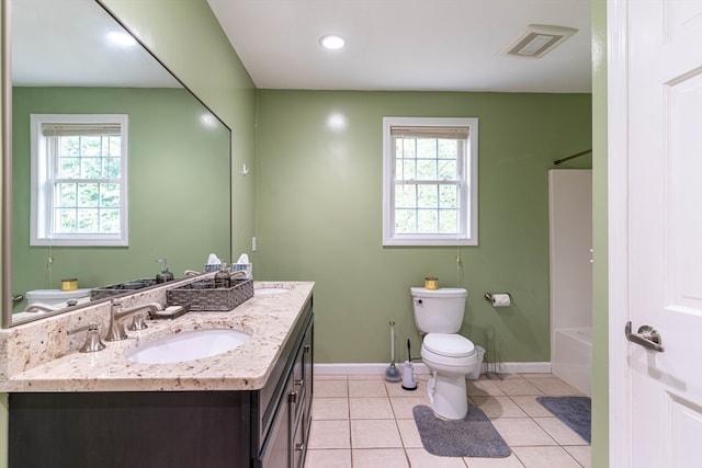 full bathroom featuring washtub / shower combination, tile patterned floors, toilet, and vanity