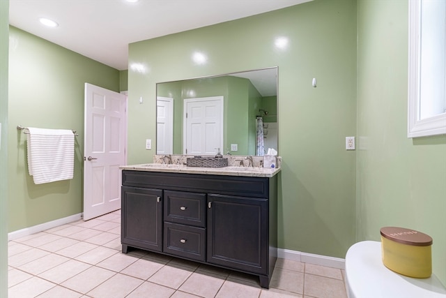 bathroom with tile patterned flooring and dual bowl vanity