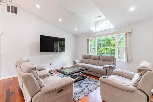 living room featuring wood-type flooring and vaulted ceiling