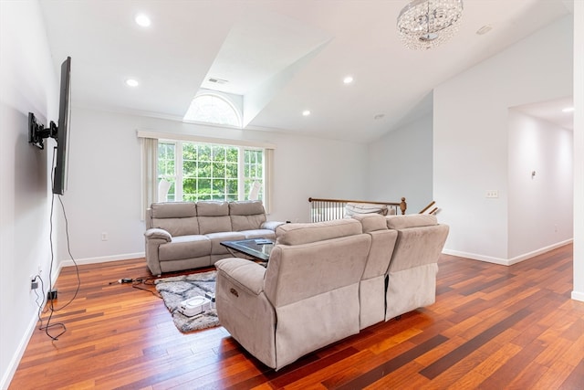 living room featuring vaulted ceiling and dark hardwood / wood-style flooring