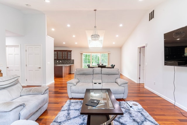 living room with dark hardwood / wood-style floors and high vaulted ceiling