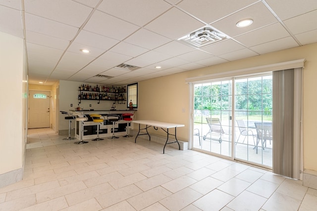 interior space featuring a drop ceiling and light tile patterned floors