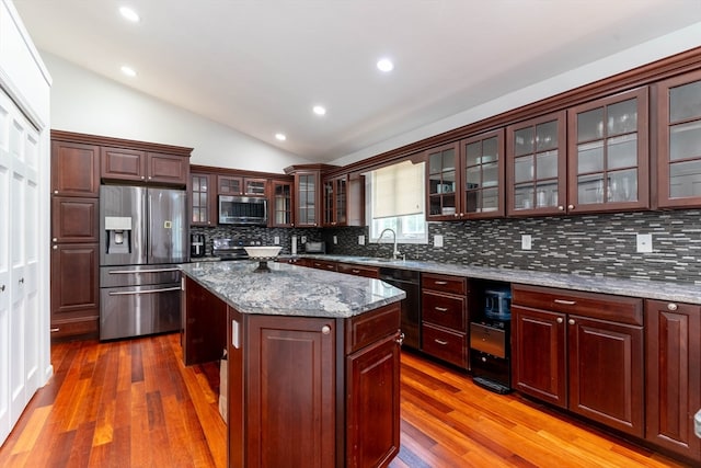 kitchen with decorative backsplash, hardwood / wood-style floors, and stainless steel appliances