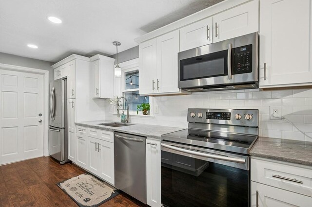 41 Dick Dr, Worcester, MA 01609 - kitchen featuring stainless steel appliances, a sink, white cabinets, dark wood-style flooring, and recessed lighting