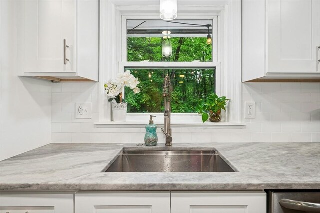 41 Dick Dr, Worcester, MA 01609 - kitchen with a sink, dishwasher, white cabinetry, and tasteful backsplash