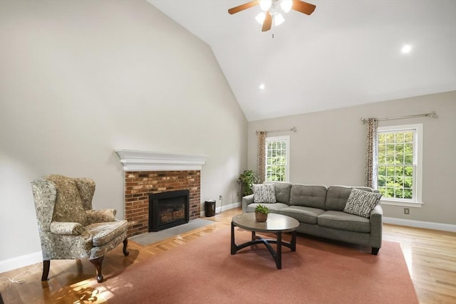 17 Sean Mikeal Way, Grafton, MA 01519 - living area featuring high vaulted ceiling, ceiling fan, baseboards, light wood-style flooring, and a brick fireplace